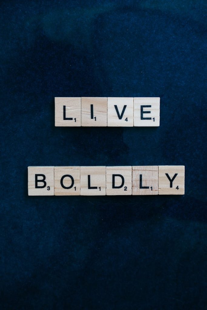 Scrabble tiles forming 'Live Boldly' on a dark blue background for motivation.