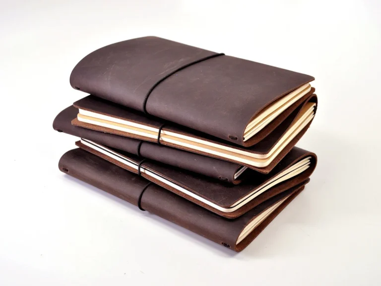 A stack of brown leather journals